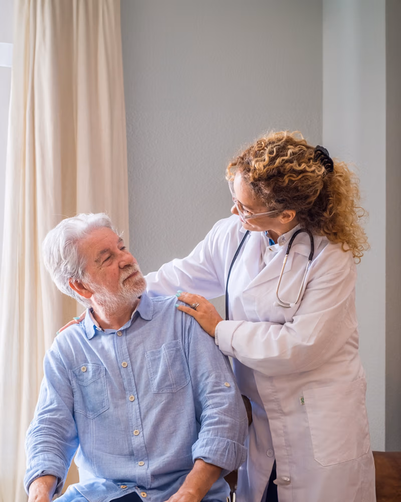 Caregiver providing attentive memory care support to senior resident at Kuno Haus Cypress TX